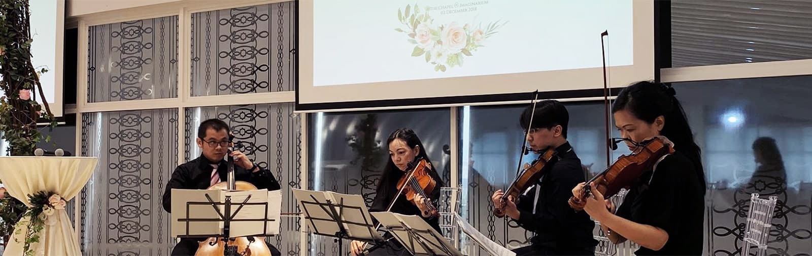 A string quartet playing at a chapel wedding solemnisation